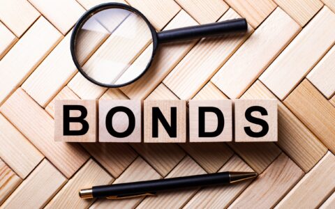 Wooden,Cubes,With,The,Word,Bonds,Stand,On,A,Wooden